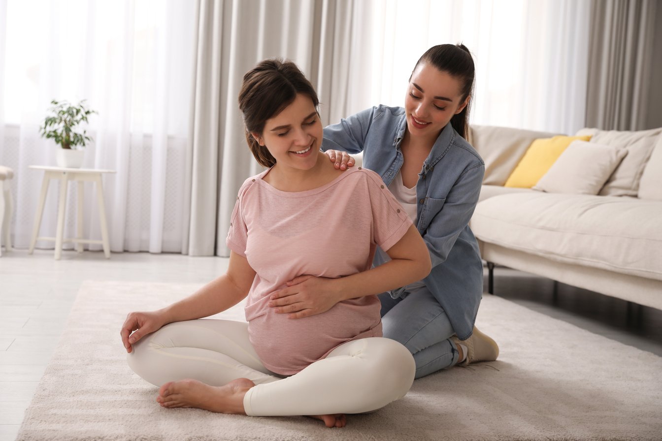 Doula Working with Pregnant Woman in Living Room. Preparation Fo